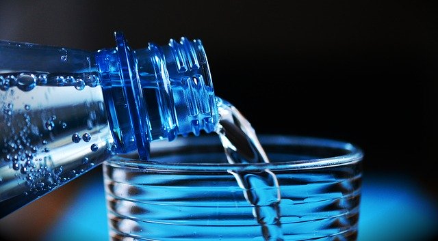 Water being poured into a plastic cup