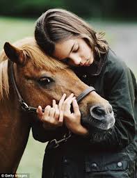 Woman holding horse